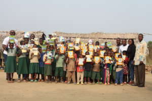 Kids holding new exercise books with team