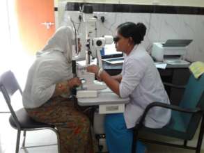 Kalpana checking the eyes of a patient