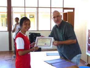 A student receiving her certificate