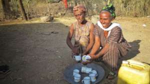 Aselefech (right) washes cups with her neighbor