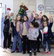 Children gather around the Christmas tree at SCC