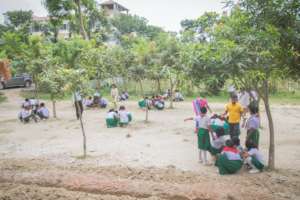 Students painting flower pots and planting trees.