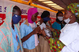 Female students trying on new masks