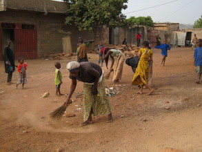Women in Sikoro sweeping the trash