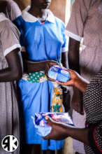 Girls receiving their own AFRIpads Kit