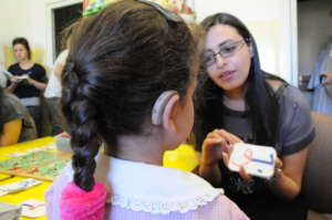 A deaf child with her teacher learning Arabic