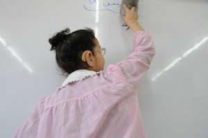 Primary school student writing in Arabic