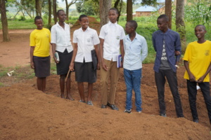 Musenyi students explaining their tiered garden