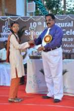 A girl student getting a recognition award