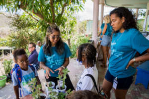 Student volunteers teach kids about plants.