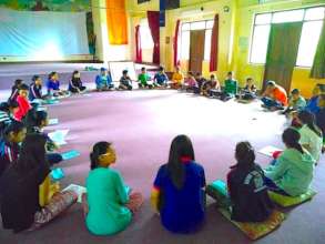 Students in Nepal participate in a healing circle