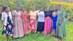 Women stand together smiling after a workshop.
