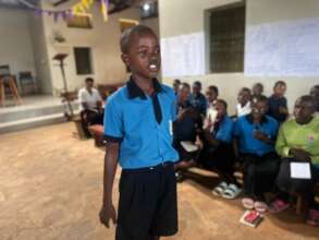 A young boy leads a breathing practice