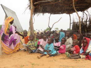 Khadiga now teaches children outside in the shade