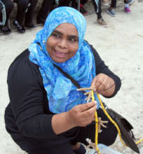 Community leader attaching coral to nursery rope