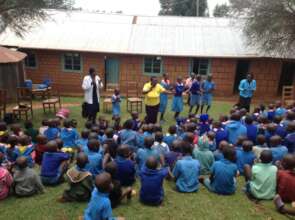 Pupils, teacher and Gladys singing.