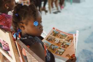 A Girls' Club member holds training materials.