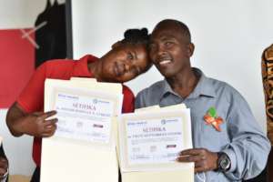 A Lavale pastor and his wife hold their diplomas.