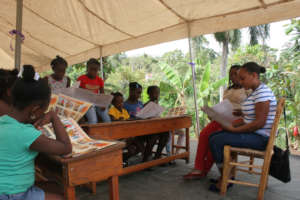 Mentors guide girls in discussion at a girls club.