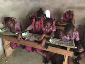 Students using Power To Girls in the classroom.