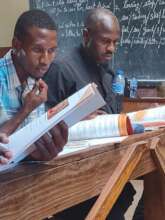 Teachers study Power To Girls materials.