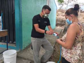 Tango Helping with a Water Filter in Valle Arriba