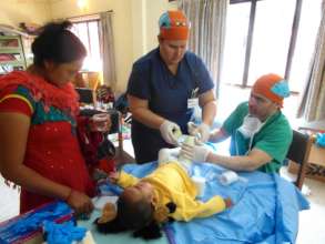 HTC Doctors Assessing Child Post-Surgery