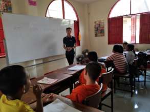 Chen teaching English, Shan, and Burmese languages