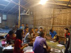 Su teaching children at a construction site