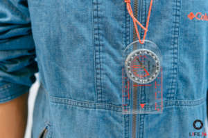 Handing out compasses to campers for hiking