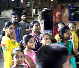 Community members watch an Action Event