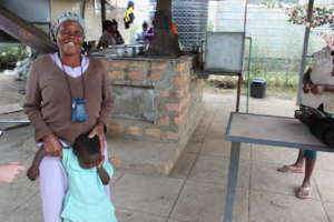 An Elderly Woman at a Community Cooker