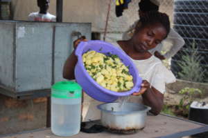 A young mother preparing to cook food to sell