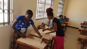 Women attending vocational training on tailoring
