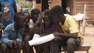 Community children engage with handwashing poster