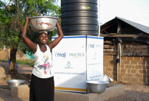 Woman fetches water from MajiPlus System
