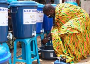 Community leader uses Maji Bucket to wash his hand