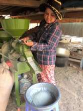 Sarer prepares rice for chicken feed