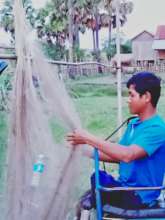 Vann's husband, fixing the fishing nets