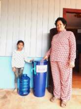 Mother and child receiving a biosand water filter