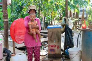 Mother and baby with their BioSand Water Filter