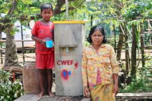 Mother with son drinking clean water from filter