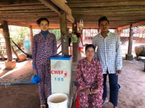 Yun with his family next to a CWEF water filter