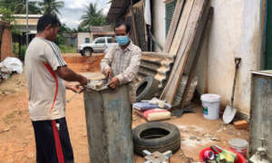Volunteers in Tboung Khmum prepare BioSand Filters
