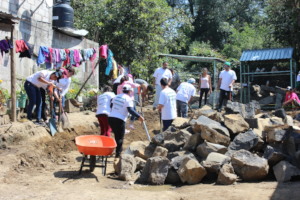 Volunteers digging the foundation for a new home