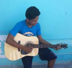 Luis bought his own guitar, via school business