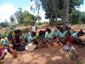 Stundents in the shade with teacher