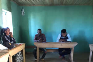 Meeting in the painted classroom with new desks