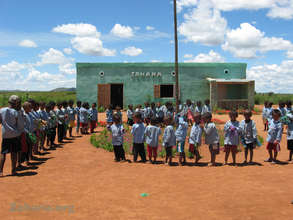 Sudents and teacher with their school