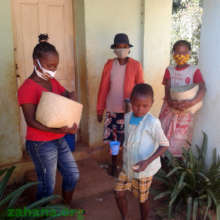 Teacher and cooks distributing mofo gasy